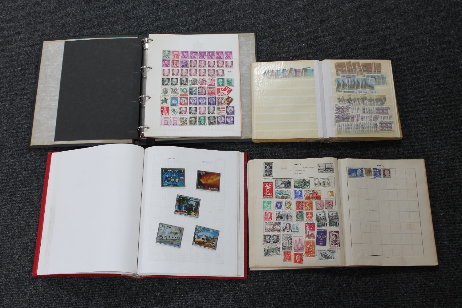 Four albums of stamps