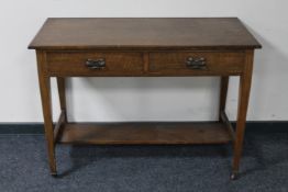 An Edwardian oak two drawer desk