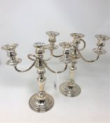 A pair of silver plated three branch candelabra,