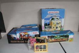 A boxed Sylvanian Families deluxe country mansion, boxed country bus, caravan,
