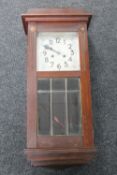 An Edwardian mahogany wall clock with pendulum