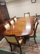 A high quality Charles Barr inlaid mahogany twin pedestal extending dining table with leaf,