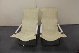 A pair of mid century folding lounge chairs