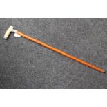 An early 20th century ivory handled walking stick with silver mounts, inscribed F.