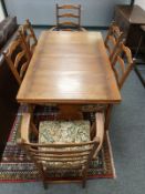 An Ercol elm pull out refectory dining table, (137 cm length un extended), together with six chairs.