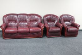 A three piece Burgundy leather lounge suite