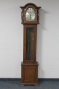 An oak cased Tempus Fugit longcase clock with weights and pendulum