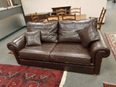 A three piece brown leather lounge suite by Duresta (settee length 210 cm).