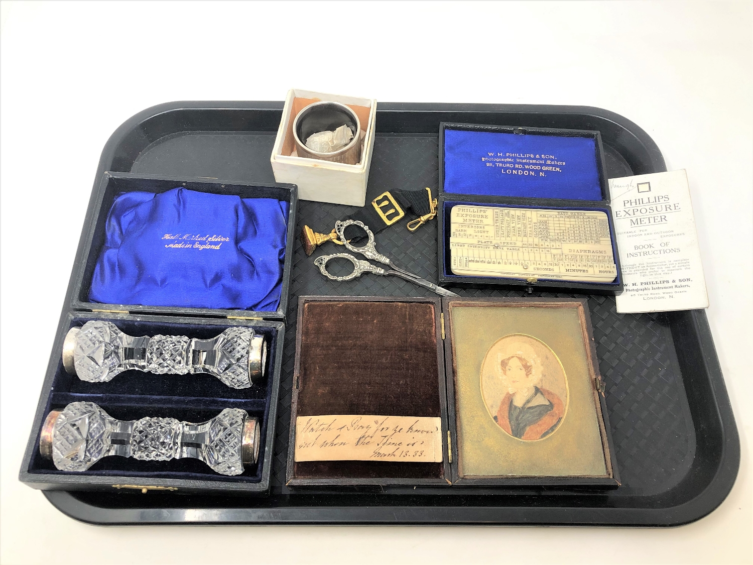 A tray of Phillip's Exposure Meter in original case, pair of cased silver and cut glass knife rests,