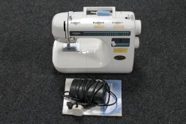 A Brother PS-35 electric sewing machine with pedal and instruction book