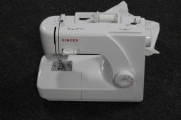 A Singer electric sewing machine with foot pedal