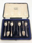A cased set of six silver teaspoons with tongs,