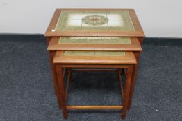 A nest of three mid twentieth century Danish teak tiled tables