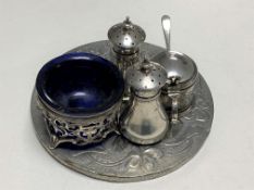 A three piece silver cruet set together with a silver salt and a metal mirrored embossed plaque