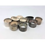 Nine heavy gauge silver serviette rings, 307g.