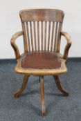 An Edwardian leather seated swivel office chair