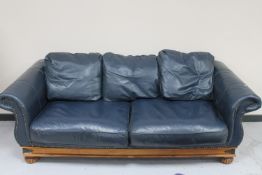 A blue leather three seater settee,
