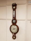 A Victorian mahogany banjo barometer with silvered dial,