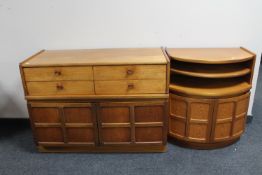 A mid twentieth century teak double door cabinet fitted with four drawers together with a D-shaped