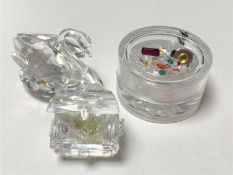 A Swarovski crystal swan together with a treasure chest and lidded pot containing elements