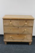 An antique pine four drawer chest