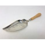 A fine quality ornate Edwardian silver crumb scoop with ivory handle