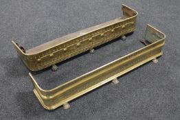 Two antique brass fire curbs on paw feet