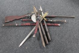 A box of ornamental weapons, axes, samurai swords, pair of brass handled swords,