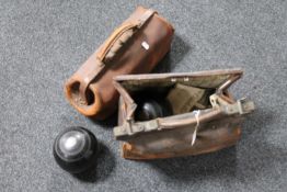 Two antique leather bags containing two pairs of lawn bowls