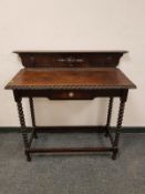 An oak bobbin turned hall table fitted with a drawer,