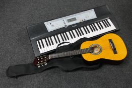 A Yamaha electric keyboard on stand together with a child's acoustic guitar in carry bag