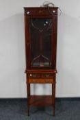 A reproduction mahogany display cabinet on stand fitted with three drawers