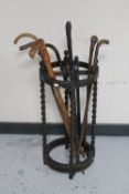 An antique oak barley twist stick stand (no tray) together with seven antique and later walking