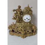 A late 19th century gilt figural mantel clock with enamelled dial,