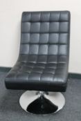 A black vinyl contemporary swivel chair on chrome base