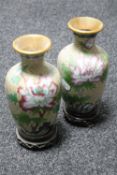 A pair of cloisonne vases on wooden stands