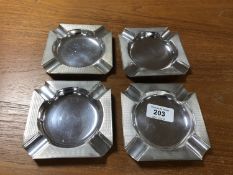 A set of four silver ashtrays with engine turned decoration,