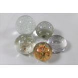 Five glass paperweights to include a Waterford crystal Stuart advertising paperweight
