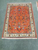 A Malayer rug, on salmon ground,