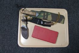 A tray of machete in sheath,