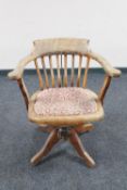An antique oak swivel captain's chair