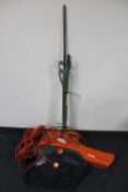 A Flymo garden vacuum together with a bundle of garden tools