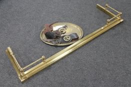 An antique brass extending fire curb,