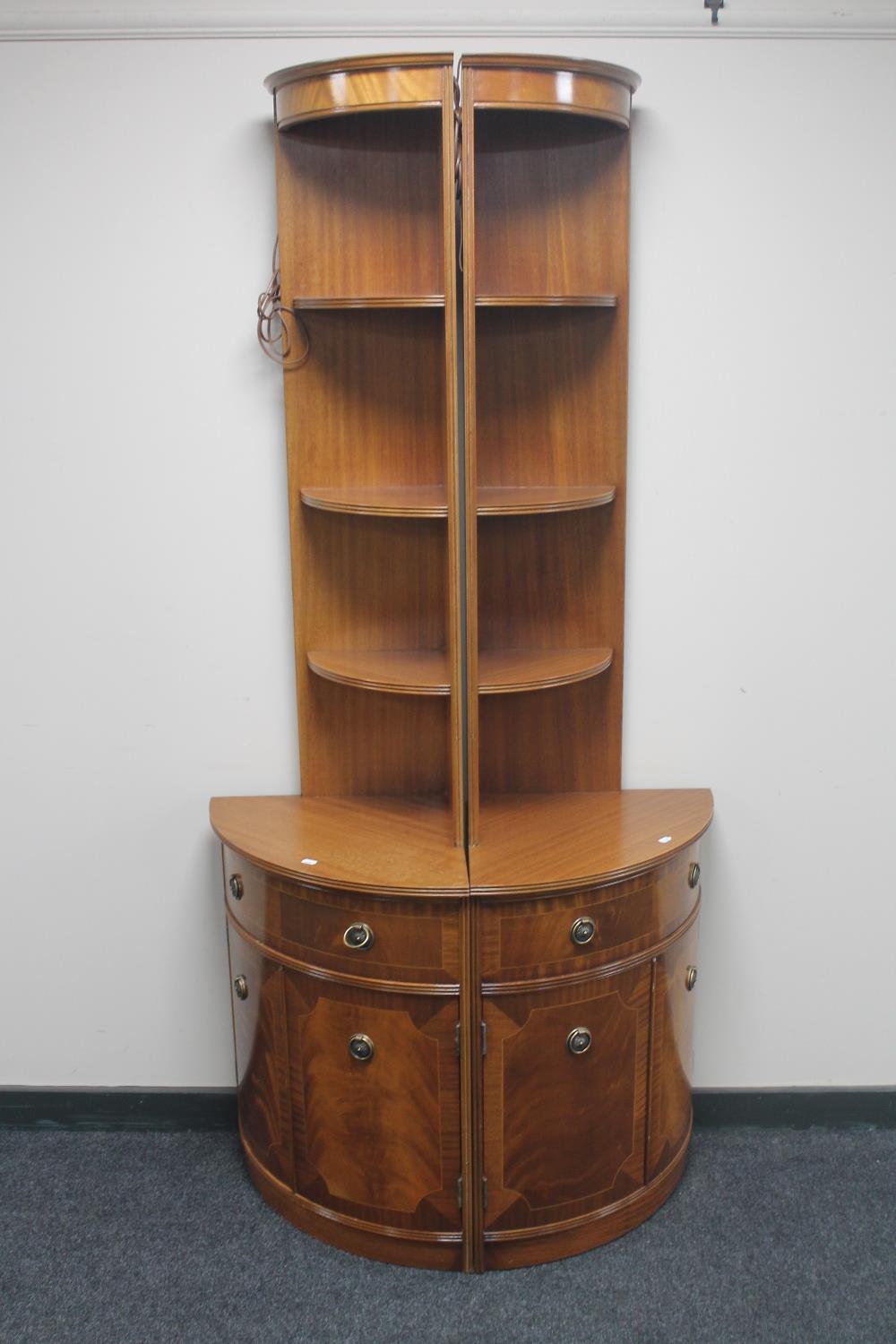 A pair of twentieth century inlaid mahogany corner stands