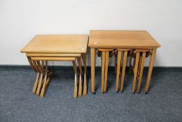 A nest of three twentieth century teak tables together with a further nest of four teak tables