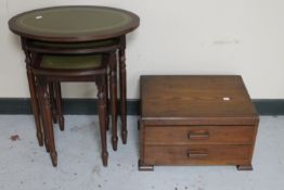 A nest of three mahogany leather topped tables together with an Edwardian oak two drawer cutlery