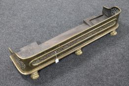 A Victorian brass fire curb on paw feet