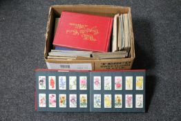 A box of cigarette card albums and cards by Wills,
