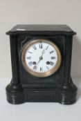 A Victorian slate mantel clock with enamel dial