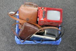 A basket of miniature portable TV, cased AVO meter, cased binoculars Megger meter,